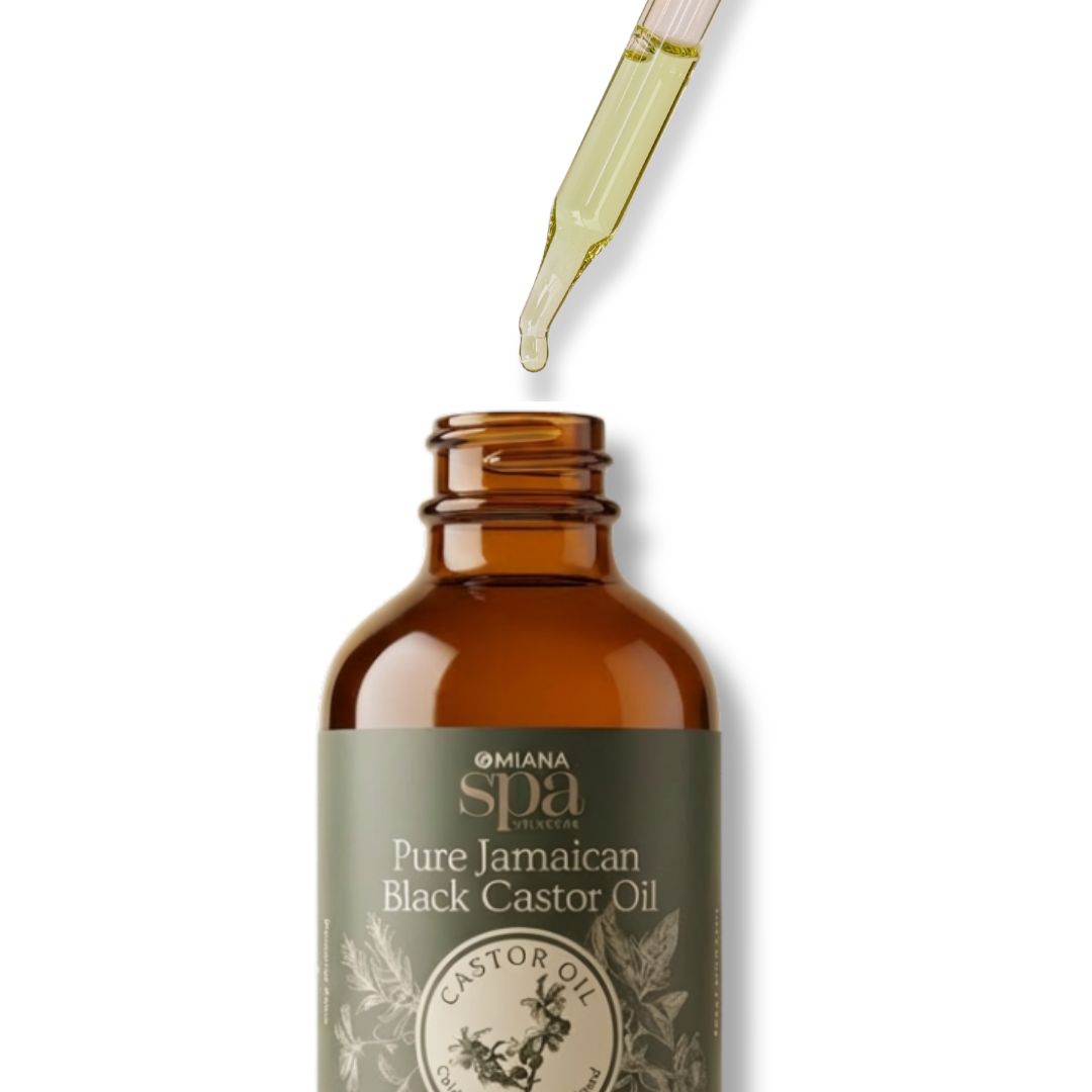 Bottle of Omana Spa Pure Jamaican Black Castor Oil with a dropper on a white background
